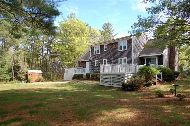 225 Simon Narrows Road Mashpee, MA 02649 - Photo 4 of 22 a front view of a house with garden and trees