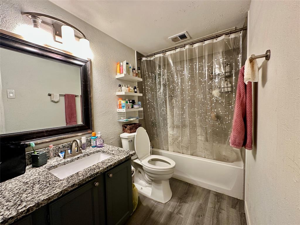 18333 Roehampton Drive, Unit 313 Dallas, TX 75252 - Photo 12 of 19 a bathroom with a granite countertop sink toilet and shower