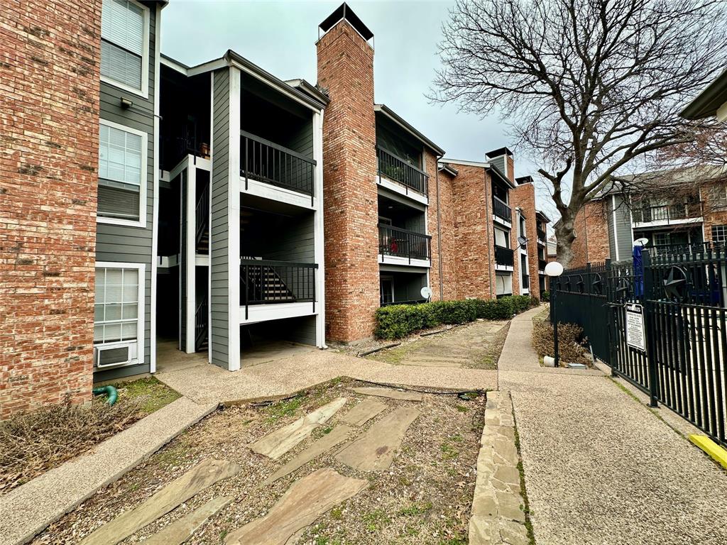 18333 Roehampton Drive, Unit 313 Dallas, TX 75252 - Photo 15 of 19 a view of a house with a door and chair