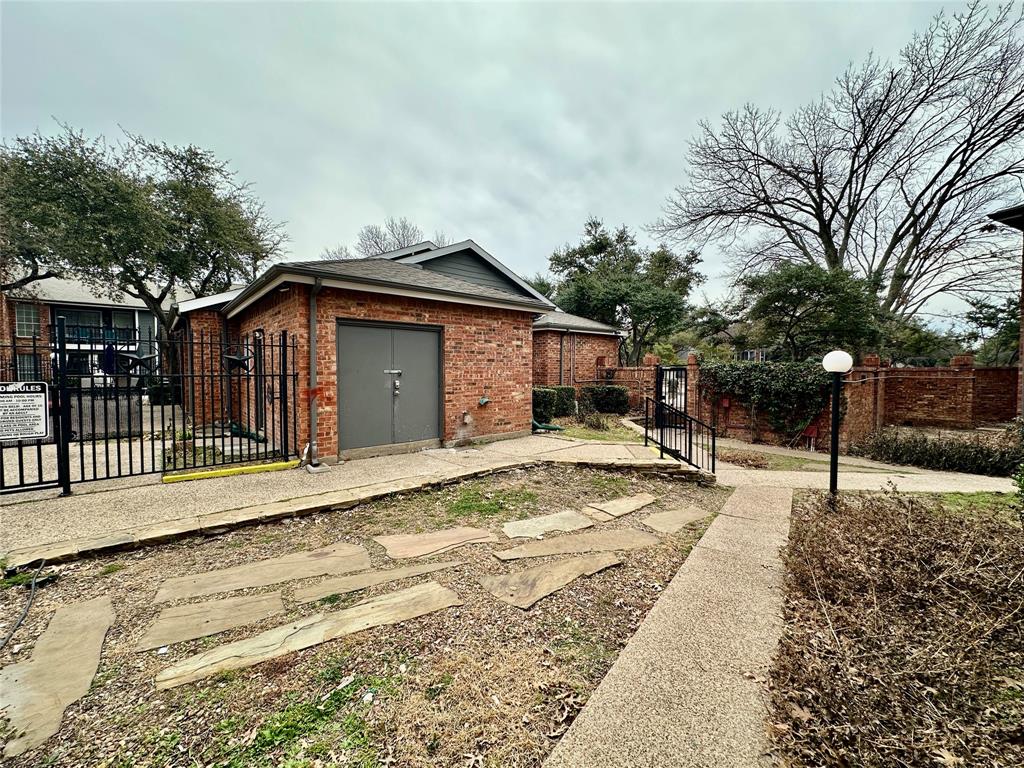 18333 Roehampton Drive, Unit 313 Dallas, TX 75252 - Photo 16 of 19 a front view of a house with a yard and seating space