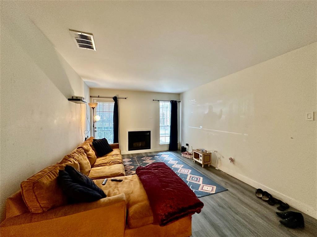 18333 Roehampton Drive, Unit 313 Dallas, TX 75252 - Photo 4 of 19 a living room with furniture and a fireplace