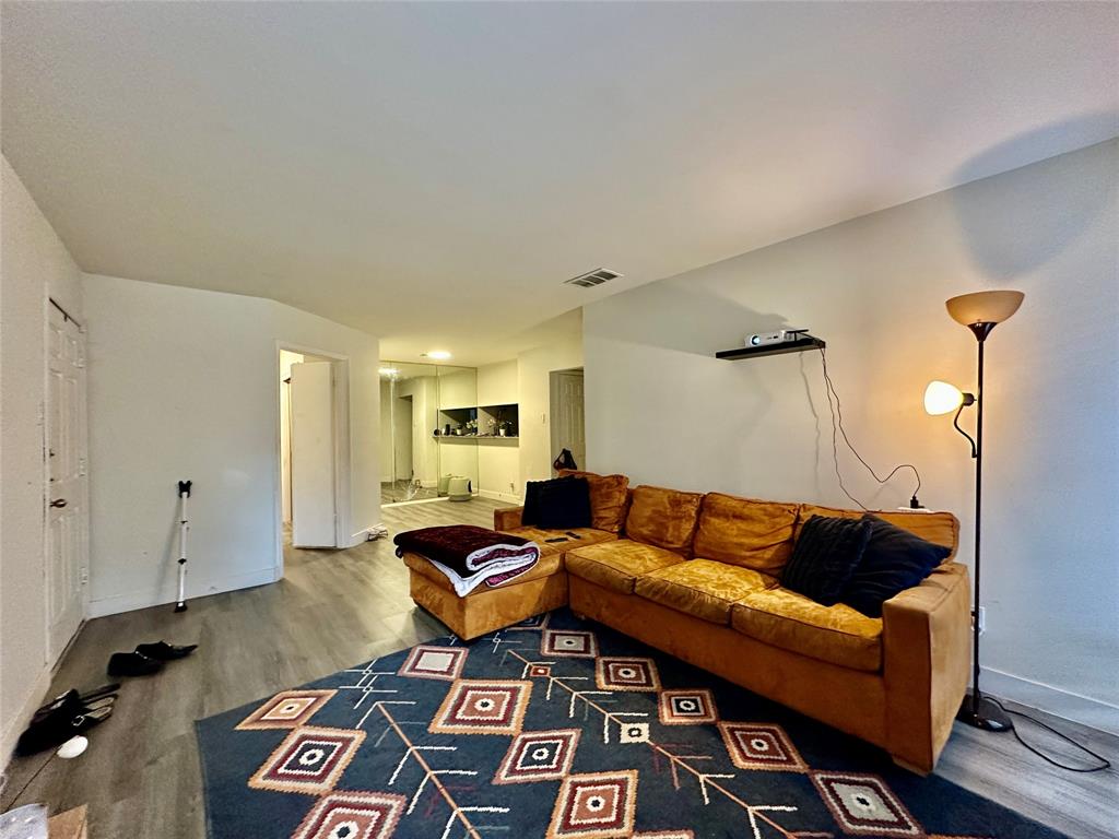 18333 Roehampton Drive, Unit 313 Dallas, TX 75252 - Photo 5 of 19 a living room with furniture and a rug