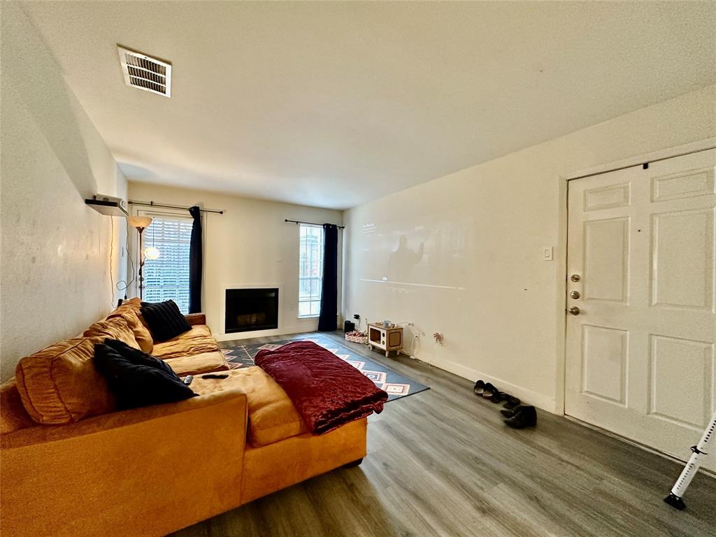 18333 Roehampton Drive, Unit 313 Dallas, TX 75252 - Photo 6 of 19 a bed room with a bed and a fireplace