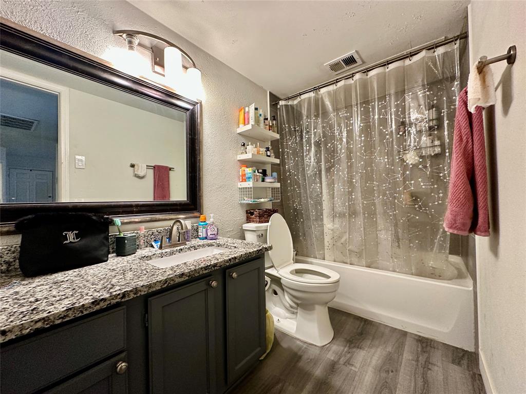 18333 Roehampton Drive, Unit 313 Dallas, TX 75252 - Photo 10 of 19 a bathroom with a double vanity sink toilet and shower