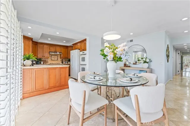 a kitchen with refrigerator cabinets and stove top oven