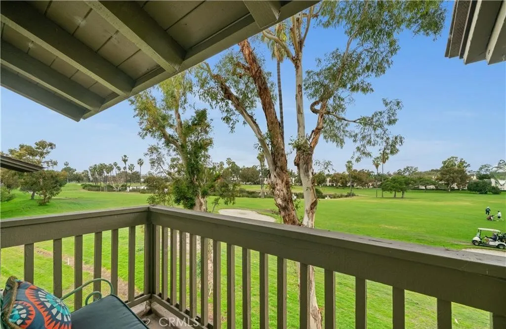 17 Verde, Unit 23 Irvine, CA 92612 - Photo 22 of 52 a view of a two chair under an umbrella in a balcony