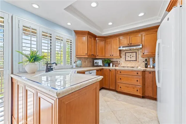 a kitchen with stainless steel appliances granite countertop a sink and cabinets