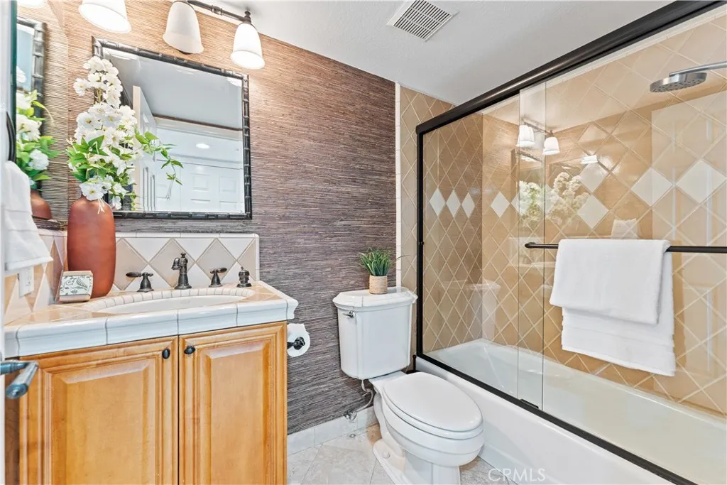 17 Verde, Unit 23 Irvine, CA 92612 - Photo 30 of 52 a bathroom with a granite countertop sink toilet and shower