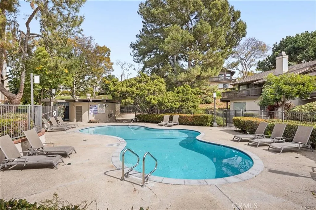 17 Verde, Unit 23 Irvine, CA 92612 - Photo 45 of 52 a view of a swimming pool with a patio