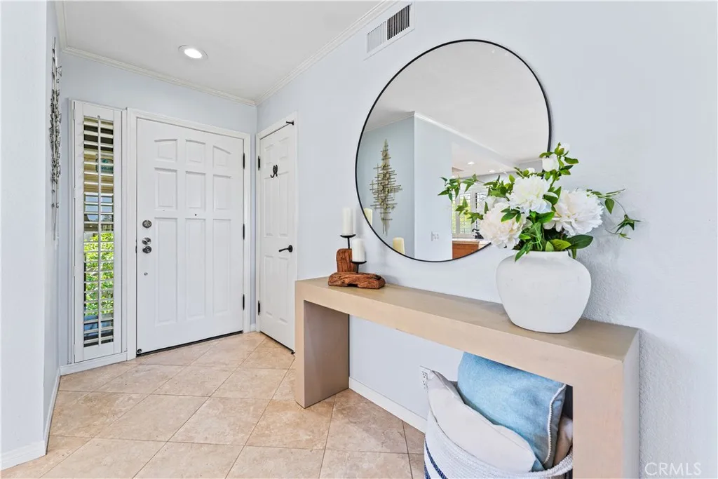 17 Verde, Unit 23 Irvine, CA 92612 - Photo 8 of 52 a room with round mirror and chandelier