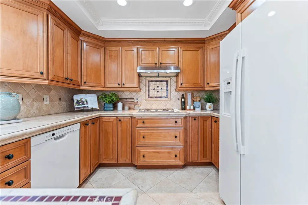 17 Verde, Unit 23 Irvine, CA 92612 - Photo 9 of 52 a kitchen with stainless steel appliances granite countertop a stove a sink and a refrigerator