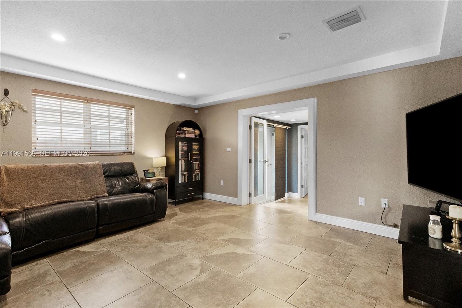 3500 Southwest 13th Street Miami, FL 33145 - Photo 11 of 51 a living room with furniture and a flat screen tv