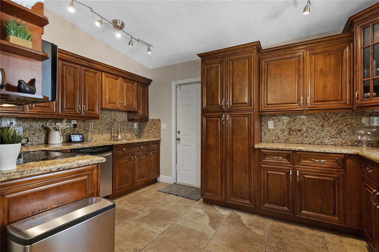 3500 Southwest 13th Street Miami, FL 33145 - Photo 20 of 51 a kitchen with granite countertop wooden cabinets stainless steel appliances and a sink