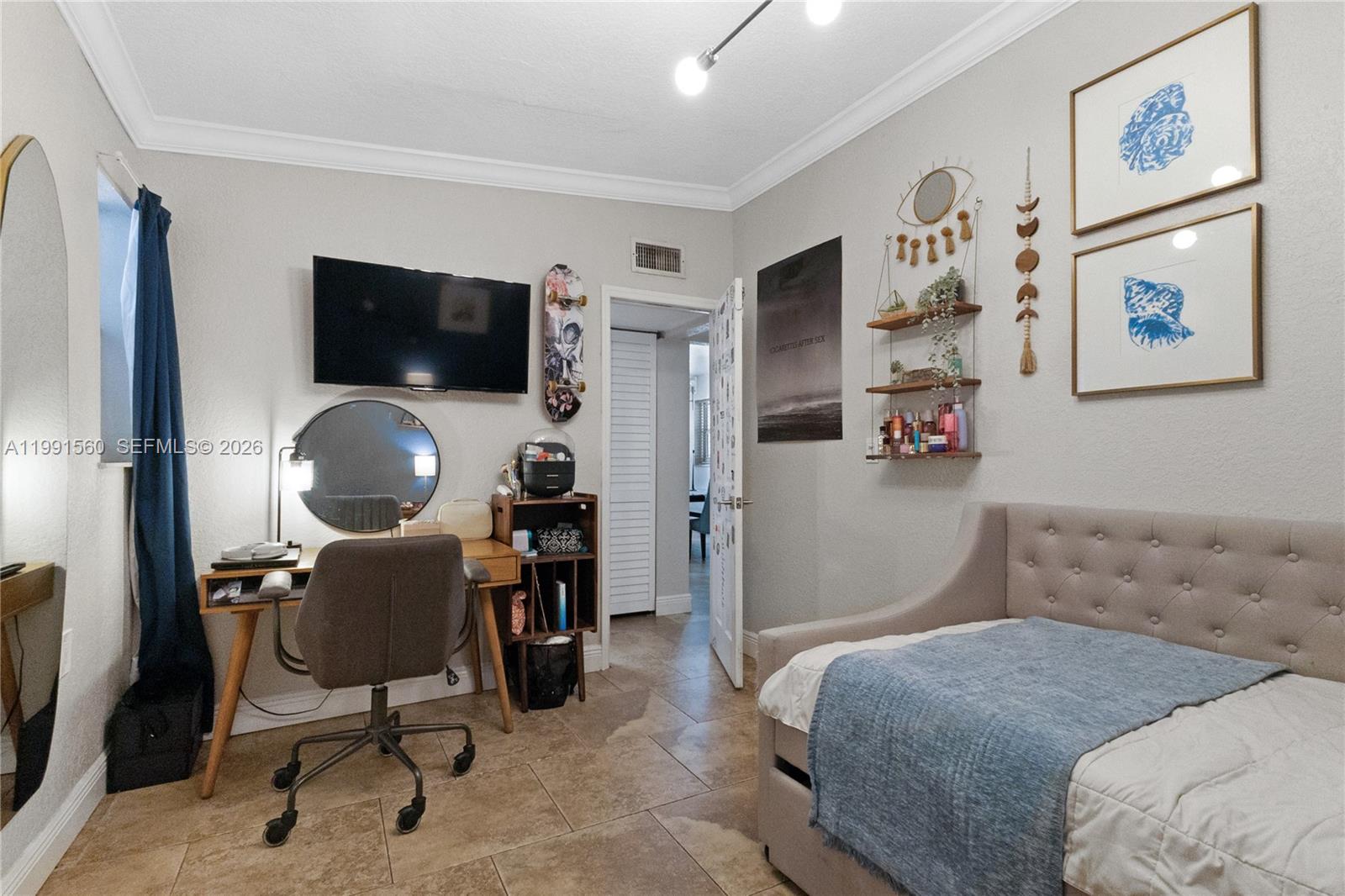 3500 Southwest 13th Street Miami, FL 33145 - Photo 37 of 51 a bedroom with a chair and a flat screen tv