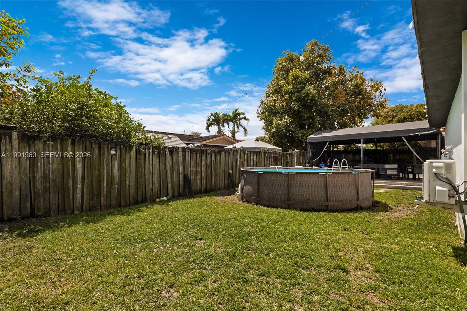 3500 Southwest 13th Street Miami, FL 33145 - Photo 51 of 51 a view of a backyard with table and chairs and wooden fence