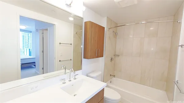 a bathroom with a bathtub shower sink and toilet