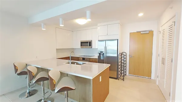 a kitchen that has a sink a table and chairs in it
