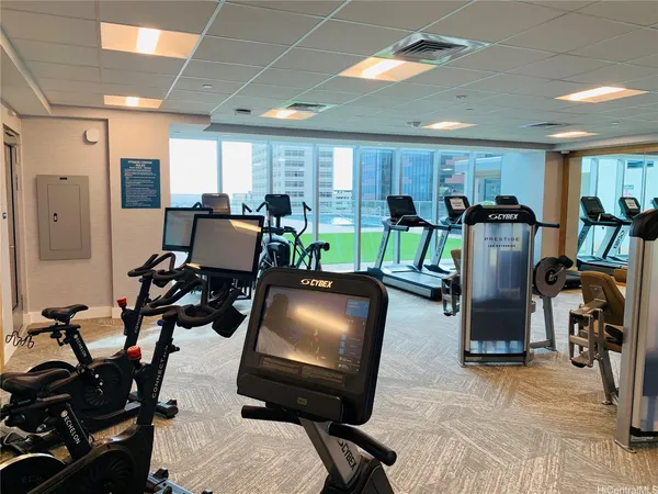 a room with gym equipment and windows