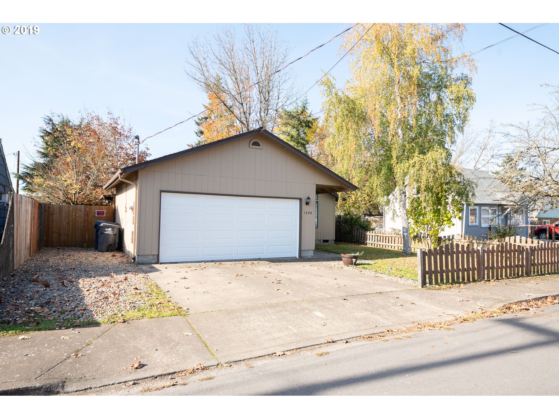 1298 8th Street Springfield, OR 97477 - Photo 3 of 25 a front view of a house with a yard and garage