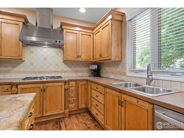 a kitchen with stainless steel appliances granite countertop a sink a stove and a microwave
