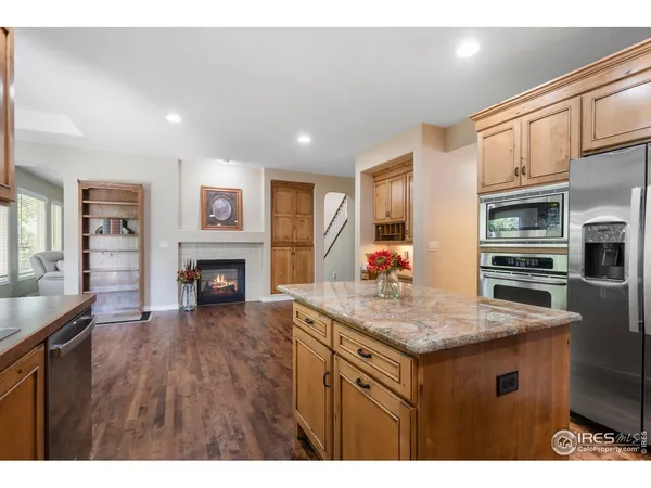 a kitchen with cabinets and wooden floor