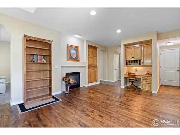 a view of a livingroom with a fireplace and window