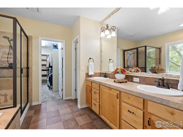 a spacious bathroom with a double vanity sink shower and a mirror