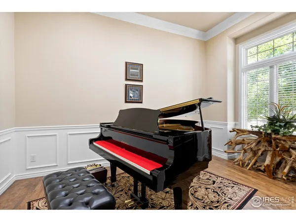 a living room with furniture and a piano