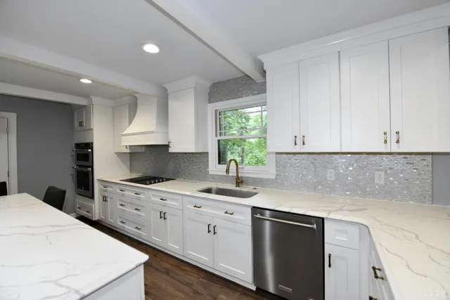 a kitchen with granite countertop white cabinets sink and stainless steel appliances