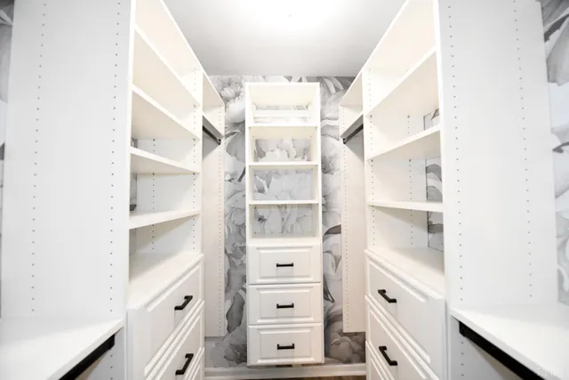 a view of a kitchen with white cabinets