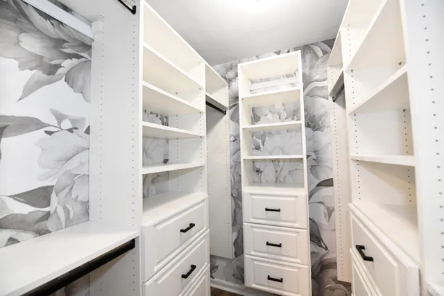 a view of a kitchen with cabinets and window