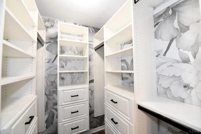 a view of walk in closet with empty racks