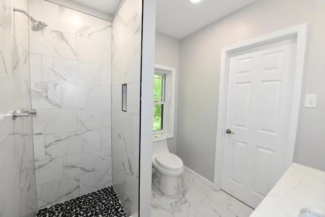 a bathroom with a shower and a toilet
