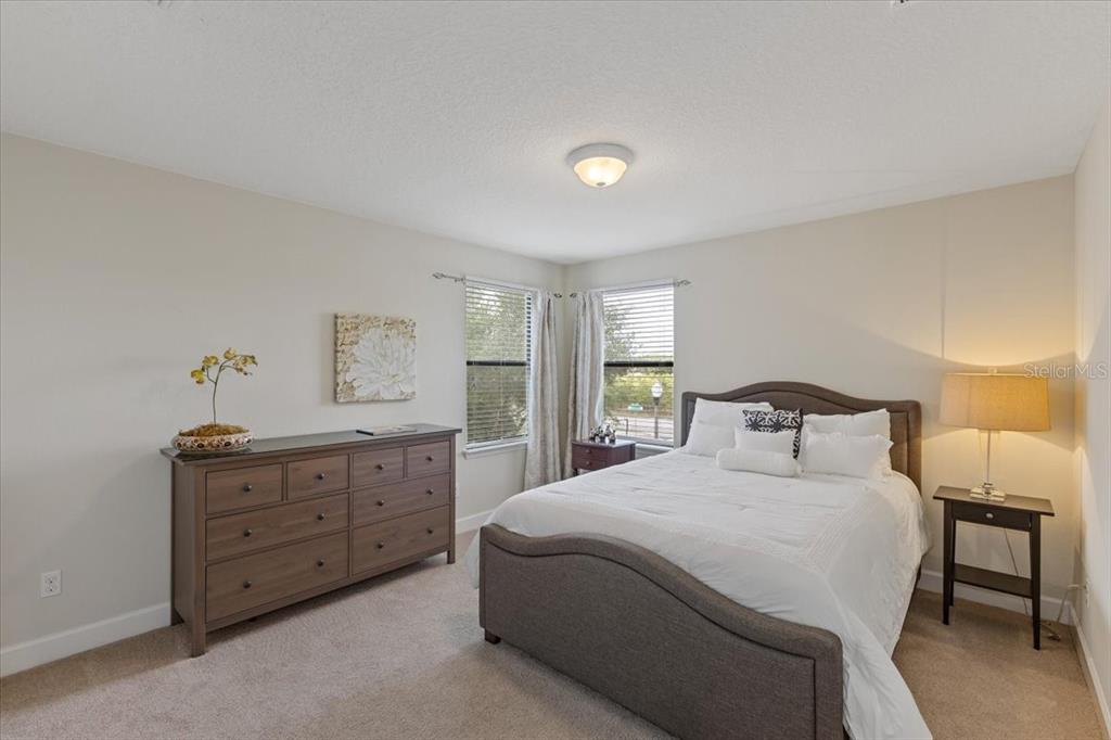 7180 Beek Street Windermere, FL 34786 - Photo 25 of 33 a bedroom with a bed and a dresser