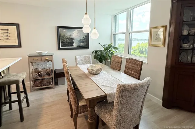 a view of a dining room with furniture window and wooden floor