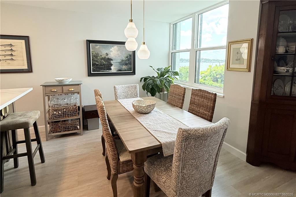 1950 Southwest Palm City Road, Unit 14101 Stuart, FL 34994 - Photo 11 of 36 a view of a dining room with furniture window and wooden floor