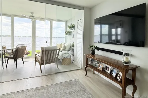 a dining room with furniture and large windows