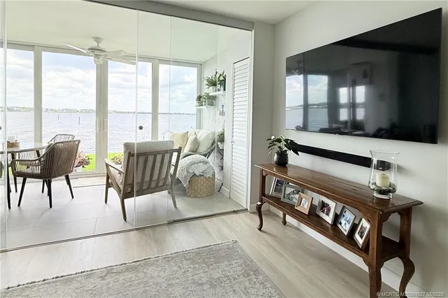 a dining room with furniture and large windows