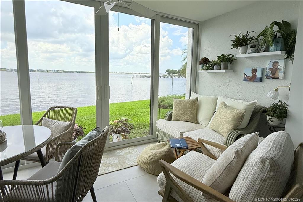 1950 Southwest Palm City Road, Unit 14101 Stuart, FL 34994 - Photo 20 of 36 a living room with furniture and a large window