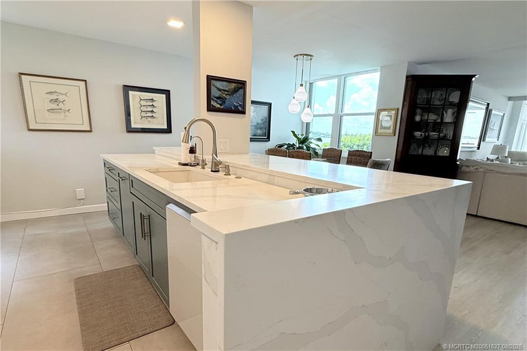 1950 Southwest Palm City Road, Unit 14101 Stuart, FL 34994 - Photo 2 of 36 a large kitchen with kitchen island a sink a stove a dining table and chairs