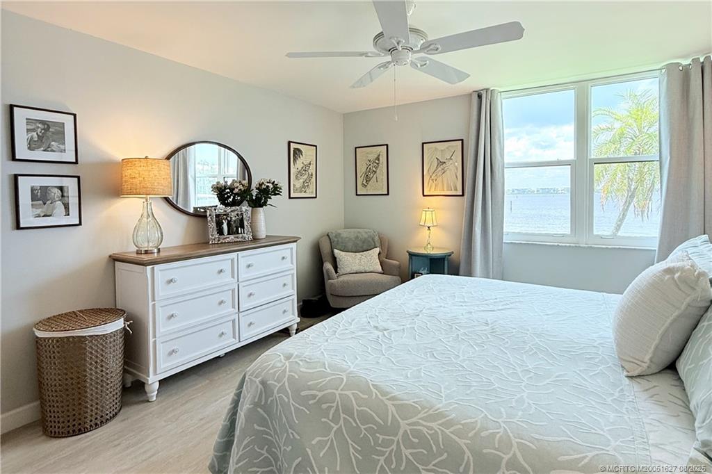 1950 Southwest Palm City Road, Unit 14101 Stuart, FL 34994 - Photo 24 of 36 a bedroom with a bed and a dresser