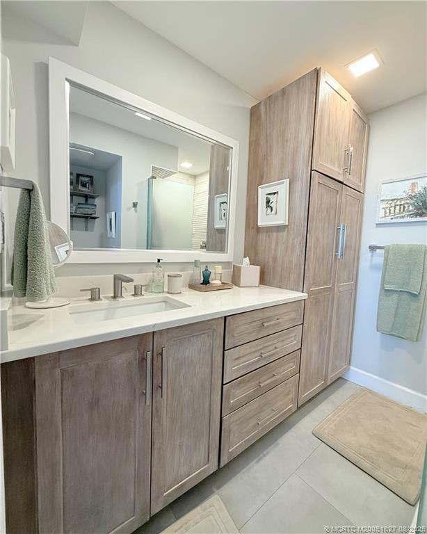 1950 Southwest Palm City Road, Unit 14101 Stuart, FL 34994 - Photo 26 of 36 a bathroom with a double vanity sink and mirror