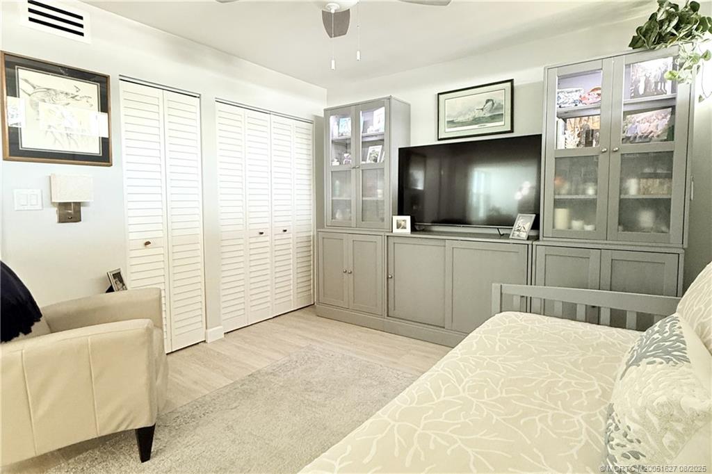 1950 Southwest Palm City Road, Unit 14101 Stuart, FL 34994 - Photo 30 of 36 a bedroom with a bed and a flat screen tv