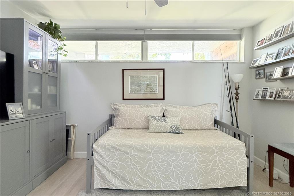 1950 Southwest Palm City Road, Unit 14101 Stuart, FL 34994 - Photo 32 of 36 a bedroom with a bed and window