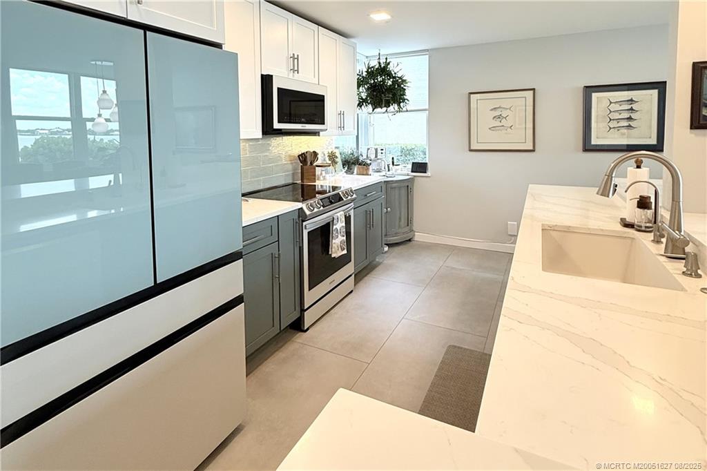 1950 Southwest Palm City Road, Unit 14101 Stuart, FL 34994 - Photo 4 of 36 a kitchen with stainless steel appliances a sink and a refrigerator