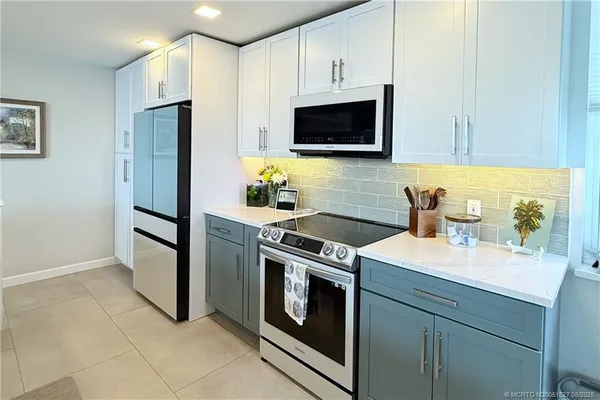 a kitchen with a sink stove and refrigerator