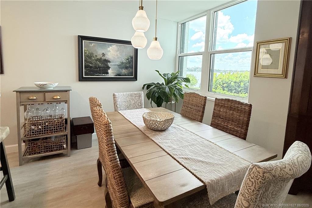 1950 Southwest Palm City Road, Unit 14101 Stuart, FL 34994 - Photo 10 of 36 a view of a dining room with furniture window and wooden floor