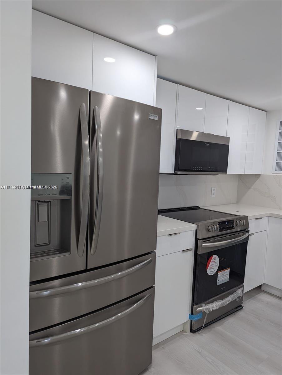 2801 Northeast 183rd Street, Unit 1709W Aventura, FL 33160 - Photo 2 of 6 a metallic refrigerator freezer sitting inside of a kitchen