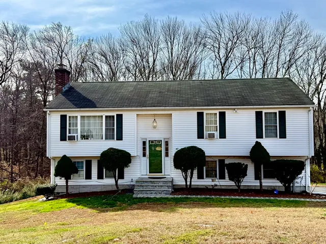 a front view of house with yard and outdoor seating