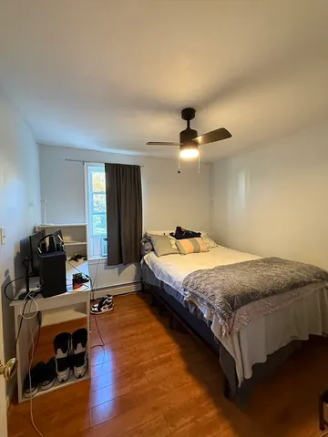 a spacious bedroom with a bed and a table in it